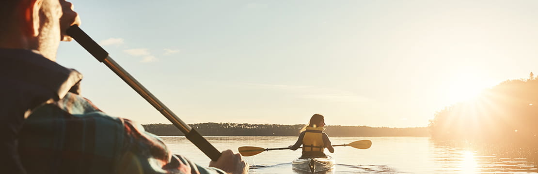 two kayakers at sunset